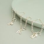 PULSERA INICIAL PLATA + PERLA ZIRCONIA